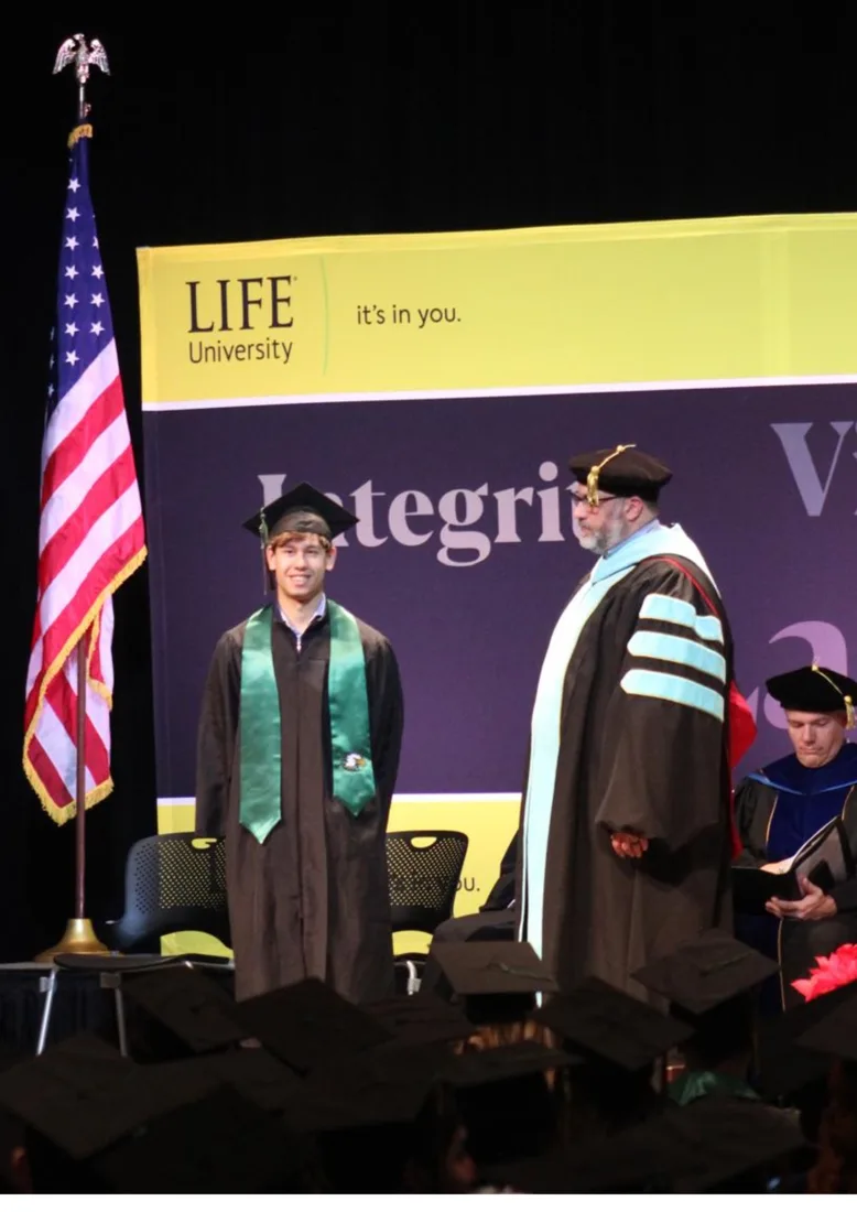 Lorenzo Peluso on stage at his Life University graduation